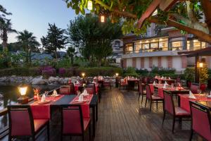an outdoor dining area with tables and chairs at Limak Limra Hotel & Resort Kemer - Kids Concept in Kemer
