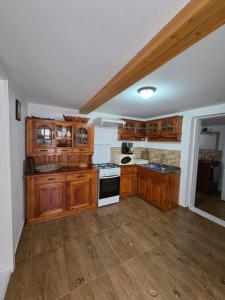 a kitchen with wooden cabinets and a stove top oven at Casa DelCris in Pojorâta