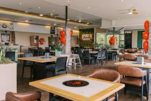 a restaurant with tables and chairs and orange balloons at Serenity Busay Room 3 in Cebu City +22 photos