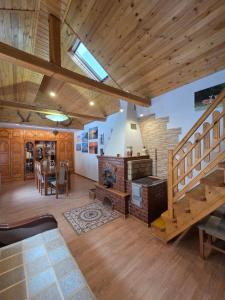 a large living room with a fireplace and a staircase at Casa DelCris in Pojorâta