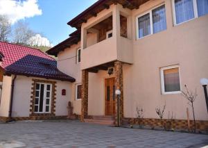 a large house with a driveway in front of it at Casa DelCris in Pojorâta