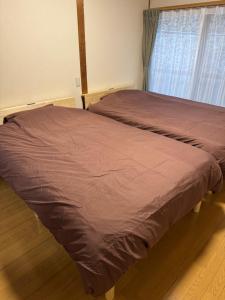 a large bed in a room with a window at ぺろんち in Shinkamigoto