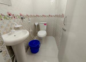 a bathroom with a toilet and a sink at Hotel Taqwa Dhanmondi in Dhaka +16 photos