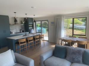 a living room with a couch and a kitchen at The Cottage at 105 in Redwoods Valley