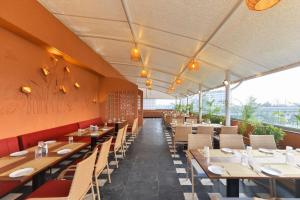 a dining room with tables and chairs and a view at Bhagwati luxuria in Indore