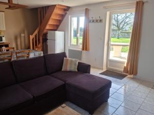 a living room with a couch and a kitchen at Gite 2min de Saumur in Saumur
