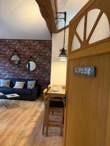 a living room with a table and a couch at Les Loges de Bacchus in Chonas-lʼAmballan