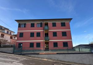 a red building on the side of a street at Ami Affittacamere 4 in Castel San Giovanni