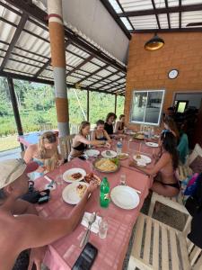 a group of people sitting around a table eating food at Divas Hostels in Ahangama
