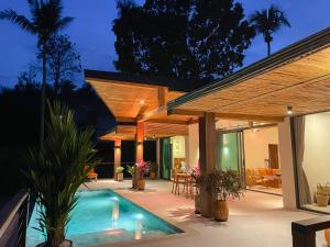 a patio with a swimming pool and a house at Altura Villa Pool & Panoramic View in Ban Nong Chaeng