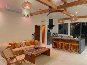 a living room with a couch and a table at Altura Villa Pool & Panoramic View in Ban Nong Chaeng
