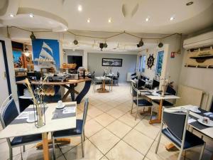 a restaurant with tables and chairs in a room at Residence Des Sources in Amnéville