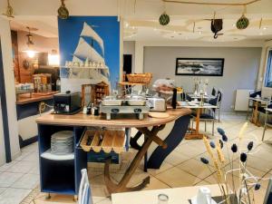 a counter in a store with a table with dishes at Residence Des Sources in Amnéville