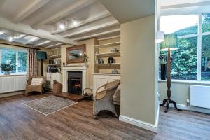 a living room with chairs and a fireplace at Finest Retreats - Dolhyfryd Lodge in Denbigh
