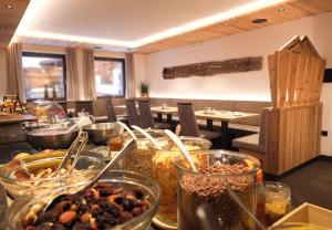 a table with many bowls of food in a restaurant at Alpshotel Bergland in Pfelders