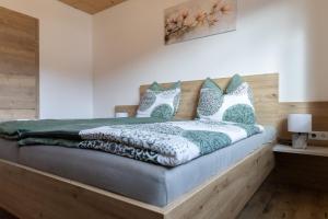 a bedroom with a bed with a wooden headboard at Huawa Appartements in Öblarn