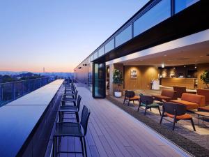a building with benches and tables on a balcony at Minn STATION Ai Nagoya in Aoichō