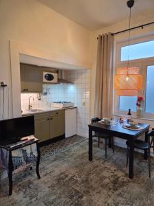 a kitchen with a table and a dining room at Riposo in West-Terschelling