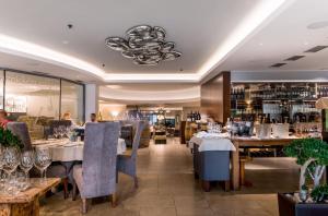 a restaurant with tables and chairs and a bar at Anenské terasy in Brno