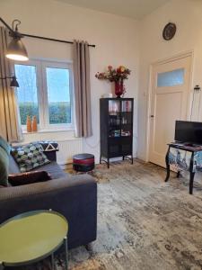 a living room with a couch and a table at Riposo in West-Terschelling