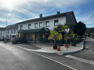 a large white building on the side of a street at Nous Cafe & Restaurant in Krumnussbaum