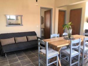 a living room with a table and a couch at Sidari High Street Apartment in Sidari