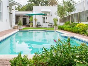 a swimming pool in the backyard of a house at Kolonie's Tuin in Stellenbosch