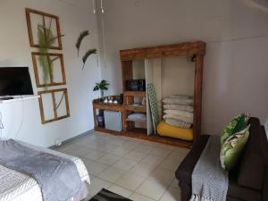 a living room with a mirror and a couch at Geckos Rest Southbroom in Southbroom