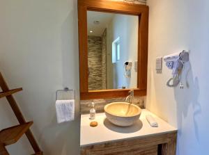 a bathroom with a bowl sink and a mirror at Cocoon Self-Catering Apartments in Anse a La Mouche +29 photos