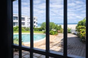 a view of a pool from a window at Orca View Melkbosstrand in Melkbosstrand