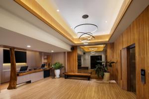 an office lobby with wood paneling and a desk at Aveta Hotel Malioboro in Yogyakarta