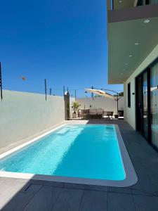 a swimming pool in the backyard of a house at Anba Solēy in Surinam