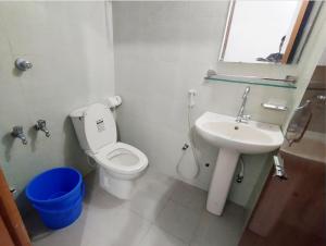 a bathroom with a toilet and a sink at Hotel Dhanmondi Prime in Dhaka