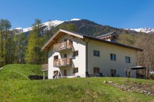 a house on a hill with mountains in the background at Ski and bike - holiday home Verbier Valley in Versegeres 