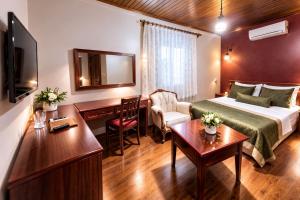 a hotel room with a bed and a desk at Osmanli Marco Pasha Hotel in Tarsus