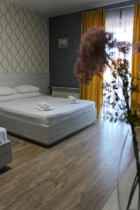 a bedroom with two beds and a vase of flowers at Rivne Hostel in Rivne