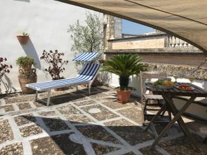 a patio with two chairs and a table at Palazzo Luceri in Galatina
