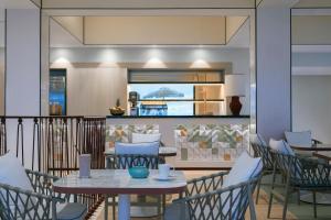a balcony with a table and chairs and a kitchen at Don Carlos Marbella in Marbella