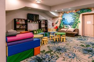 a childrens room with colorful tables and chairs at Imperiall Resort&MediSPA-DOMKI PREMIUM in Sianozety