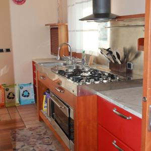 a kitchen with a stove and a sink at B & B Paradiso in Loreto