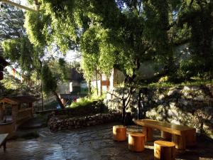 a wooden bench sitting next to a stone wall at Shangri-La mid - mountain homestay in Shangri-La