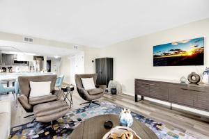 a living room with two chairs and a table at Santa Rosa Dunes 721 in Pensacola Beach