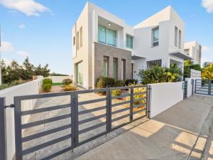 a white house with a fence at Alassia Blue Villa in Protaras