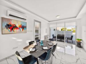 a dining room with a table and chairs at Alassia Blue Villa in Protaras