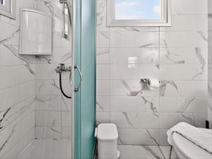 a bathroom with a shower with a toilet and a window at Alassia Blue Villa in Protaras +9 photos