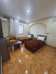 a living room with two beds and a couch at زافيرو شارع فؤاد in Alexandria
