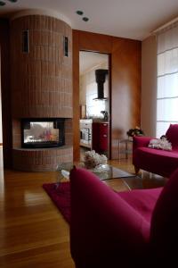 a living room with a red couch and a fireplace at B & B Paradiso in Loreto