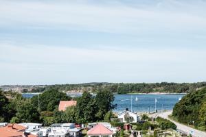 a view of a town and a river with boats at GrebbestadFjorden glampingpoddar in Grebbestad