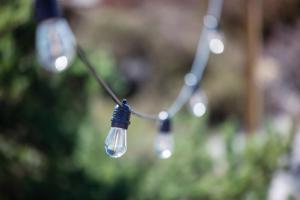 a couple of light bulbs hanging from a string at GrebbestadFjorden glampingpoddar in Grebbestad