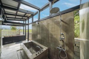 a bathroom with a large shower with a sink at TaaCH Okinawa in Nago +29 photos